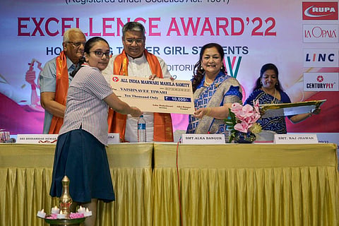 Alka Bangur, Bishambar Newar and Dinesh Bajaj felicitating a student