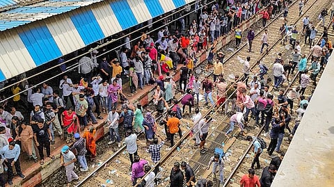 People block railway tracks at Badlapur railway station in protest against the sexual abuse of two girls at a school