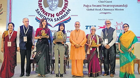 Ramnath Goenka Sahithya Samman awardees Ruskin Bond (represented by granddaughter Srishti), who was conferred the Lifetime Achievement Award (4th from L), Non-fiction award winner Neerja Chowdhury (6th from L) and Fiction award winner Aishwarya Jha (3rd from L) with (from L) TNIE CEO Lakshmi Menon, TNIE CMD Manoj Kumar Sonthalia, Chinmaya Mission global head Swami Swaroopanandaji, TNIE Editorial Director Prabhu Chawla, and TNIE Editor Santwana Bhattacharya, in New Delhi on Friday.Photo | Shekhar Yadav