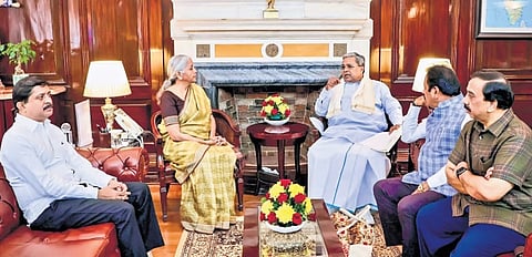Chief Minister Siddaramaiah calls on Union Finance Minister Nirmala Sitharaman to discuss the issue of NABARD funding to Karnataka being cut, as state ministers Byrathi Suresh and N Chaluvarayaswamy look on, in New Delhi on Thursday