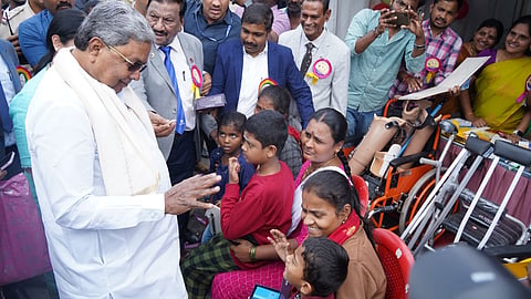 Chief Minister Siddaramaiah with Persons with Disabilities during the International Day of Persons with Disabilities at Kanteerava Stadium, in Bengaluru on Tuesday.