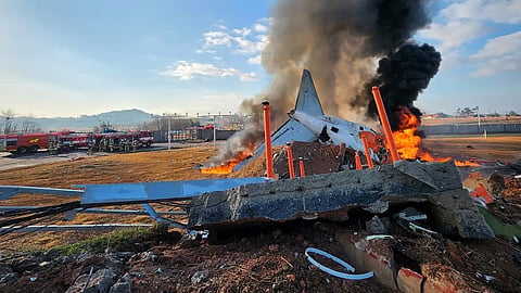 Fire and smoke rise from the tail section of a Jeju Air Boeing 737-800 series aircraft after the plane crashed and burst into flames at Muan International Airport in South Jeolla Province, some 288 kilometres southwest of Seoul on December 29, 2024