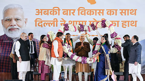 Prime Minister Narendra Modi garlanded by BJP MPs Manoj Tiwari, Bansuri Swaraj, and others during the celebrations of the party's win in the Delhi Assembly Election at the party headquarters in New Delhi on Saturday.