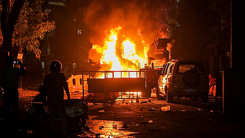 A fire set by miscreants amid violence following an agitation by a right-wing group demanding removal of Aurangzeb's tomb, in Nagpur on Monday night, March 17, 2025.