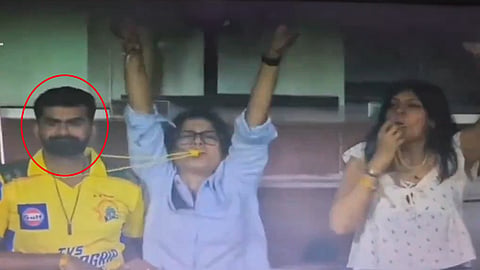 Lady blows whistle from the neck of another fan