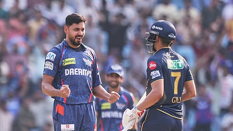 Avesh Khan, left, celebrates the dismissal of Gujarat Titans' captain Shubman Gill