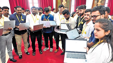 Laptops were distributed to 4,000 village administration officers, in Bengaluru on Tuesday