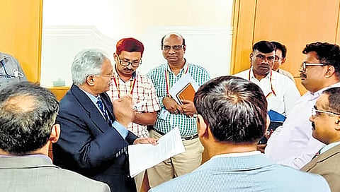 Lokayukta Justice BS Pati speaks to officials during a visit to the KSPCB head office