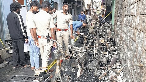 Police inspect the scene of arson