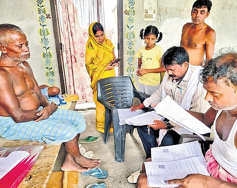 BLO officers checking document