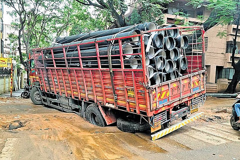 A truck carrying Bangalore Water Supply and Sewerage Board pipes stuck in slush caused by delayed civic works in Malleswaram on Monday morning.