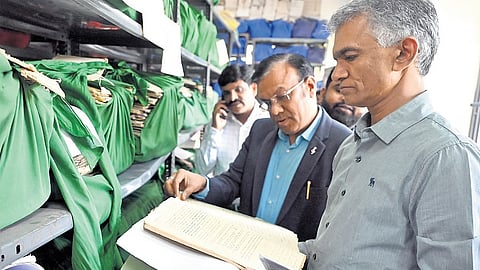 Revenue Minister Krishna Byre Gowda inspects documents after launching the ‘Bhoo Suraksha’ scheme in Bengaluru on Tuesday