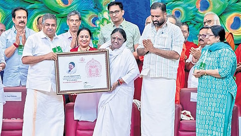 Cultural Affairs Minister Saji Cherian presenting the state government’s honour to Mata Amritanandamayi.