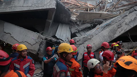 Rescuers search for victims at the site where a building under construction collapsed at an Islamic boarding school in Sidoarjo, East Java, Indonesia