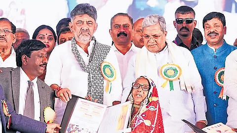 CM Siddaramaiah and Deptuy CM DK Shivakumar distribute title deeds to beneficiaries at the Bhoo Guarantee Samarpana Samavesha in Haveri on Saturday