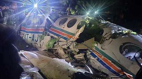 People gather near wreckage of an Redbird Airways Pvt Ltd Beechcraft C90 aircraft VT-AJV operating medical evacuation (Air Ambulance) flight