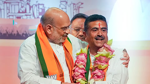 Union Home Minister Amit Shah (L) with BJP leader Suvendu Adhikari during a press conference after the BJP legislature party meeting, in Kolkata, West Bengal
