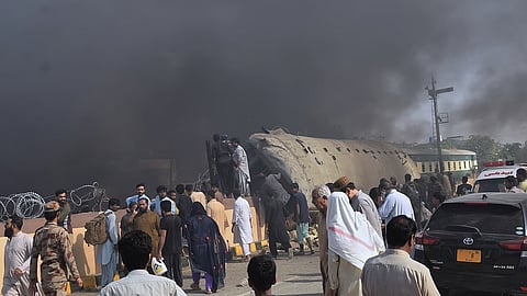 Paramilitary soldiers and volunteers recover victims from an overturned train coach on a railway track at the site of bomb explosion, in Quetta.