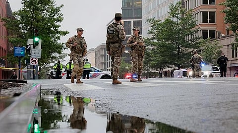 Members of the National Guard stand on the street, near the White House, after a shooting incident nearby, in Washington, DC, US.