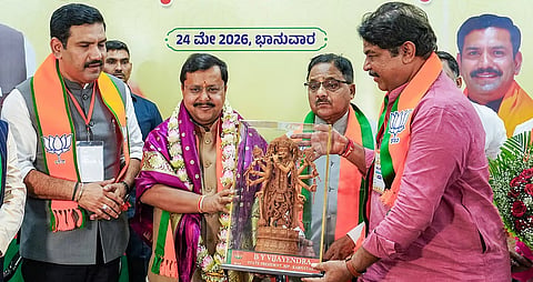 Leader of Opposition R Ashoka presents a memento to BJP national president Nitin Nabin during a meeting at the party office, in Bengaluru on Sunday.
