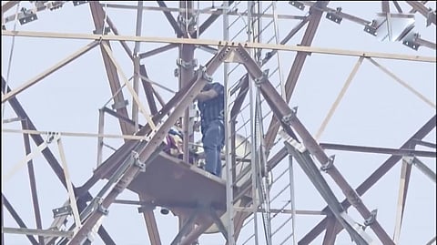 Woman climbs a 120-foot mobile tower