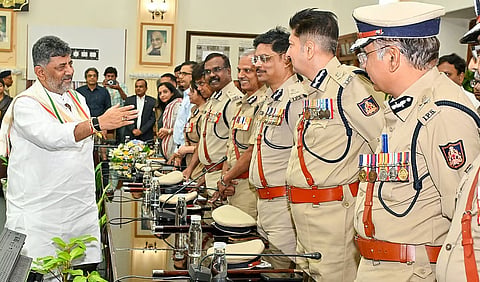 Chief Minister D K Shivakumar greets participants in a meeting of top bureaucrats and police officers at the Vidhana Soudha in Bengaluru on Thursday.