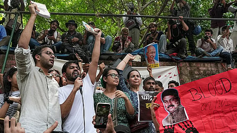 Cockroach Janta Party's (CJP) founder Abhijeet Dipke, in white, spokesperson Ashutosh Ranka, left, and others raise slogans during a protest.