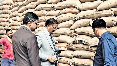 Upa Lokayukta Justice B Veerappa checks the quality of rice at a godown
