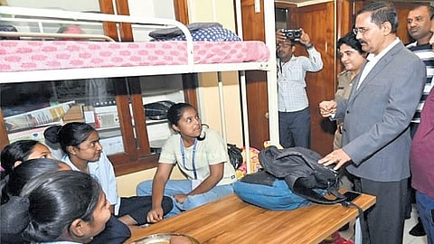Upa Lokayukta Justice B Veerappa interacts with students at Social Welfare Department hostel in Mandya during his surprise visit