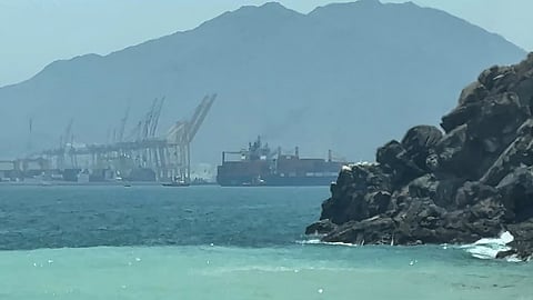 a ship sailing near the Strait of Hormuz off the eastern coast of the United Arab Emirates at Khor Fakkan.