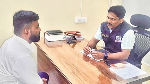 A CCB official counsels a rowdy-sheeter.