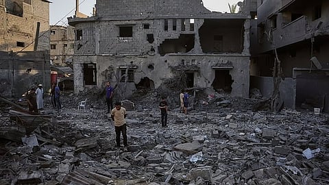 Palestinians inspect the rubble of a building destroyed in an Israeli airstrike in Deir al-Balah, central Gaza Strip, Wednesday, July 29, 2026