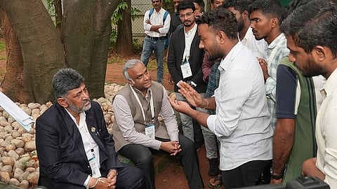 Students interact with Chief Minister DK Shivakumar in Bengaluru on Tuesday. Home Minister Priyank Kharge looks on.