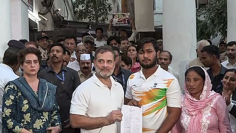 Lok Sabha LoP Rahul Gandhi and Sahil Lochab display the FIR copy after Delhi Police registered a case over Lochab's pellet injuries, in New Delhi on August 21, 2026.