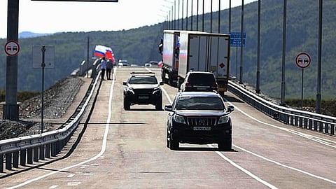 vehicles drive across the new bridge between Russia and North Korea named after the Soviet officer Yakov Novichenko