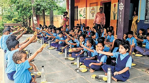 Students hold up sweets served