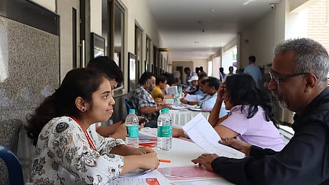 Organisers attend to senior citizens at the 11th Jobs 60+ Job Fair in Bengaluru on Sunday.