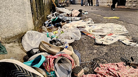 Footwear lies scattered outside a Durga Puja pandal after the exit gate collapsed due to heavy crowd pressure, leading to a stampede-like situation, in Kolkata, Saturday.