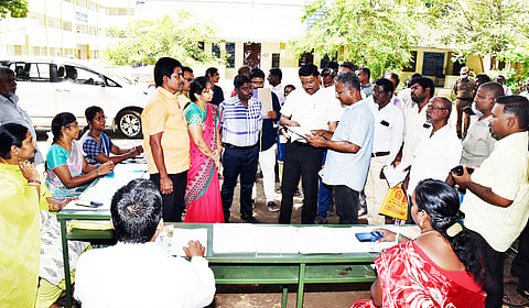 வாக்குச்சாவடி மையங்களில் வாக்காளர் அடையாள அட்டையுடன் ஆதார் எண் இணைக்கும்பணியை கலெக்டர் முருகேஷ் ஆய்வு செய்த போது எடுத்த படம்.
