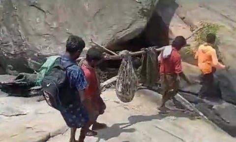 தொட்டில் கட்டி நோயாளியை தூக்கிச்செல்லும் மலைவாழ் மக்கள். 