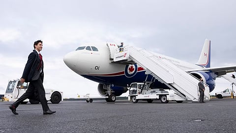 Canadian Prime Minister walking towards his official airplane.