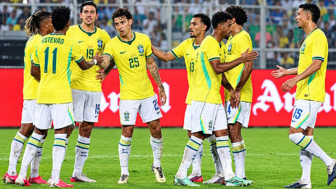 Teammates congratulate Estevão, who scored the goal.