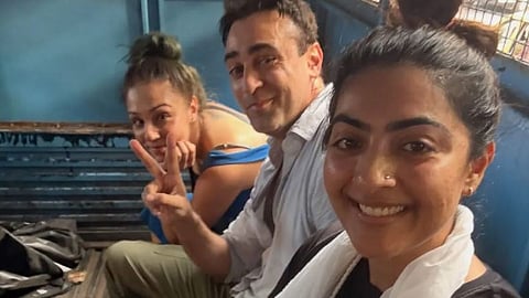 Imran Khan in police custody. His partner Lekha Washington and cousin Zain Mary Khan are nearby. (File photo)