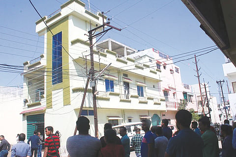 Locals gather near the house