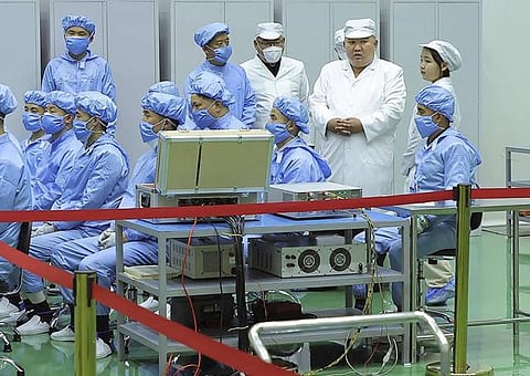 North Korea shows Kim Jong Un examining a military spy satellite that may be launched soon