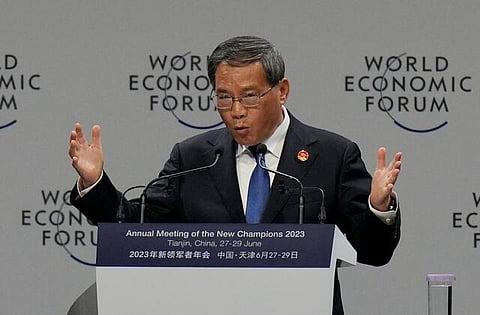 China's premier says economic growth is accelerating and the country can hit its 5% target this year