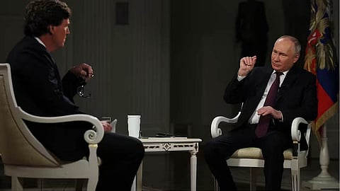 Russian President Vladimir Putin with former Fox News host Tucker Carlson
