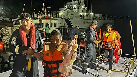 Indian Coast Guard personnel rescue passengers from a tourist ferry boat which was caught in rough weather and faced fuel exhaustion near the Mormugao harbour in Goa.
