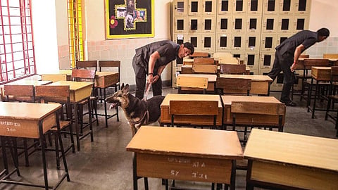 Security personnel inspect a class room at the DPS School after a bomb threat was received by the school via e-mail, at Sector 30, in Noida, Wednesday, May 1, 2024.