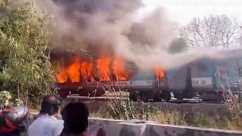 Smoke and flames billow out after four coaches of the Taj Express train caught fire, in Sarita Vihar, New Delhi, Monday, June 3, 2024.